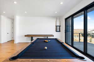 Recreation room featuring wood finished floors, recessed lighting, billiards, and baseboards
