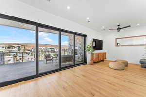 Living room featuring wood finished floors, baseboards, recessed lighting, and ceiling fan
