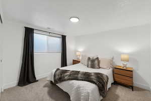 Bedroom featuring light carpet and baseboards