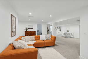 Living area with carpet and recessed lighting