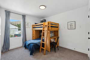 Carpeted bedroom featuring baseboards