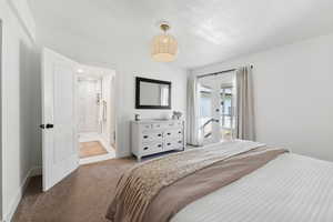 Bedroom featuring carpet, access to exterior, french doors, baseboards, and connected bathroom