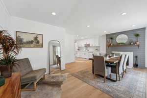 Dining space with light wood finished floors and recessed lighting