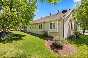 View of home's exterior featuring a yard and cooling unit
