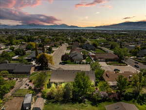 Aerial view of property's location featuring a mountainous background and nearby suburban area