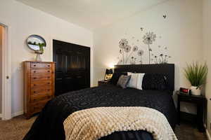 Bedroom featuring carpet, baseboards, and a closet