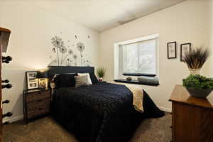 Carpeted bedroom with baseboards