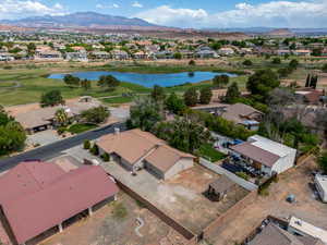 Aerial view of residential area with a water and mountain view and a local golf course