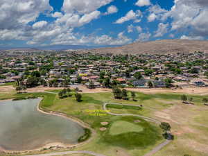 Aerial view of residential area featuring a water and mountain view and a golf course