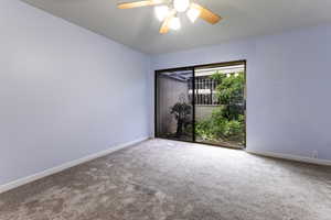 Unfurnished room with carpet, baseboards, and a ceiling fan
