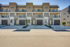 View of front facade featuring stucco siding and driveway