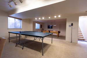 Game room with rail lighting, ornamental molding, baseboard heating, light carpet, and billiards table