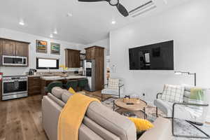 Living area featuring a ceiling fan, light wood-type flooring, and recessed lighting
