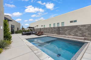 View of swimming pool featuring an outdoor lounge area and patio surround