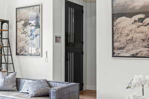 Corridor with wood finished floors and baseboards