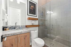 Full bath with vanity and a shower stall
