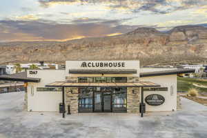 Property at dusk with view of commercial area and a mountain view