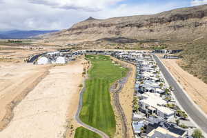 Aerial overview of property's location featuring mountains and nearby suburban area