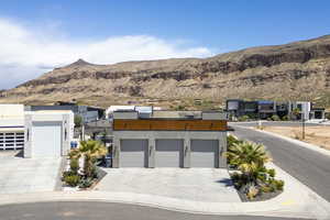 Modern home with a mountain view, stucco siding, and driveway