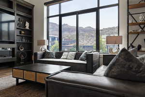 Living area featuring plenty of natural light, a mountain view, and dark wood-style flooring