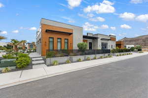 View of front of house with stucco siding and a mountain view