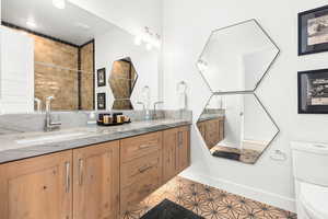 Full bathroom featuring double vanity and tile patterned floors
