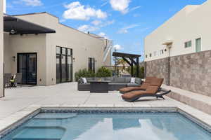 Outdoor pool with an outdoor living space, a patio area, and a pergola
