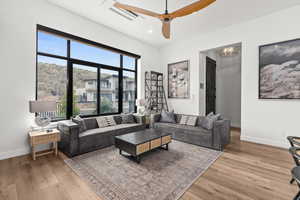 Living room featuring recessed lighting, light wood-type flooring, and a ceiling fan