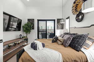 Bedroom featuring access to outside and baseboards