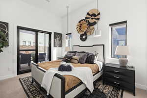 Carpeted bedroom with baseboards and access to outside