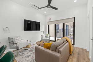 Living area featuring wood finished floors, recessed lighting, and a ceiling fan