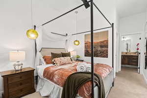 Carpeted bedroom with connected bathroom