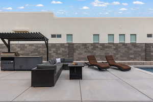 View of patio with a fire pit, an outdoor kitchen and area to lounge, and a pergola