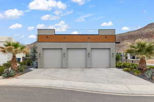 Modern home with stucco siding, a garage, and a mountain view