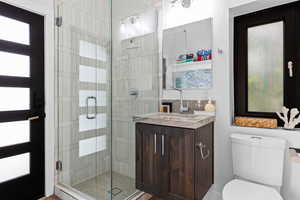 Bathroom featuring vanity and a stall shower