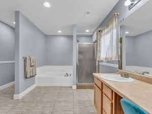 Full bathroom with vanity, visible vents, recessed lighting, a shower stall, and a garden tub