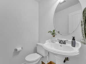 Bathroom with toilet, baseboards, and visible vents