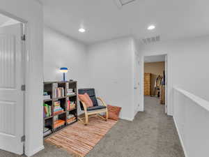 Living area with baseboards, recessed lighting, carpet flooring, and visible vents