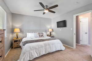 Bedroom with carpet flooring, baseboards, and ceiling fan