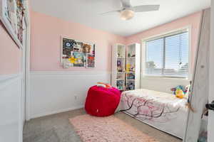 Bedroom with carpet floors and a ceiling fan