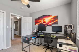 Carpeted office with ceiling fan