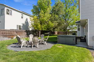 View of yard featuring a hot tub, a patio area, and a fire pit