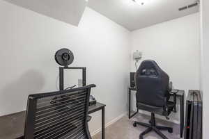 Home office with carpet floors and baseboards