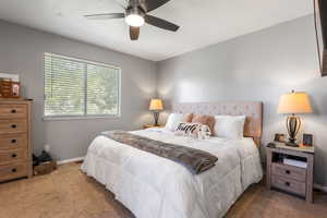 Bedroom with carpet, baseboards, and ceiling fan