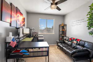Office featuring a ceiling fan, carpet, a textured ceiling, and baseboards