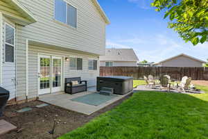 View of yard with a hot tub and a patio area