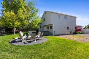 Back of property with a patio and a hot tub