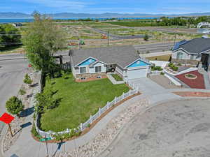 View from above of property with a mountainous background and lake