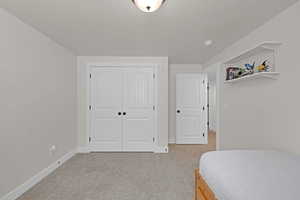 Carpeted bedroom featuring