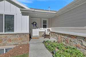 Property entrance with stone and front porch